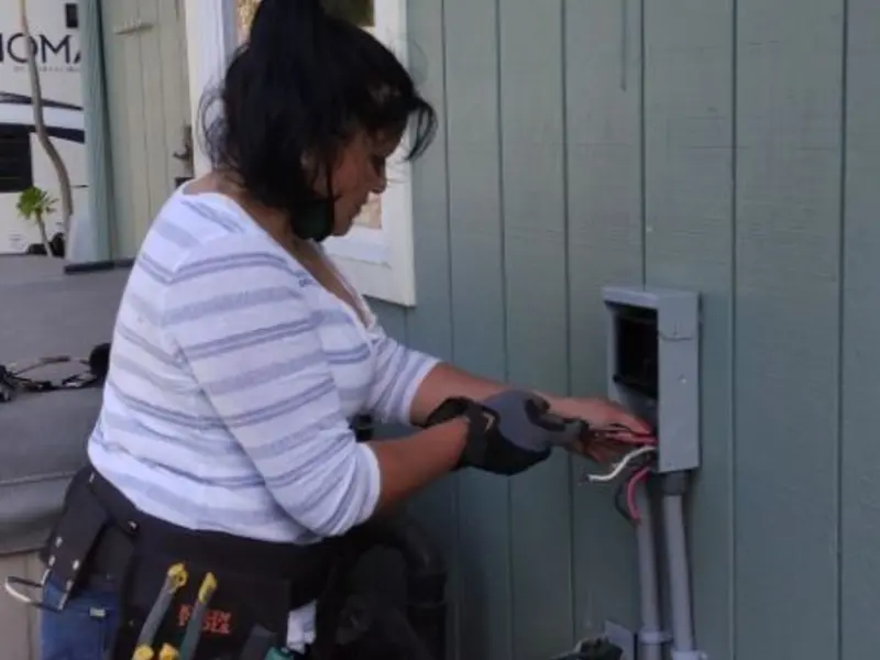Licensed electrician wiring an exterior subpanel in Okemah